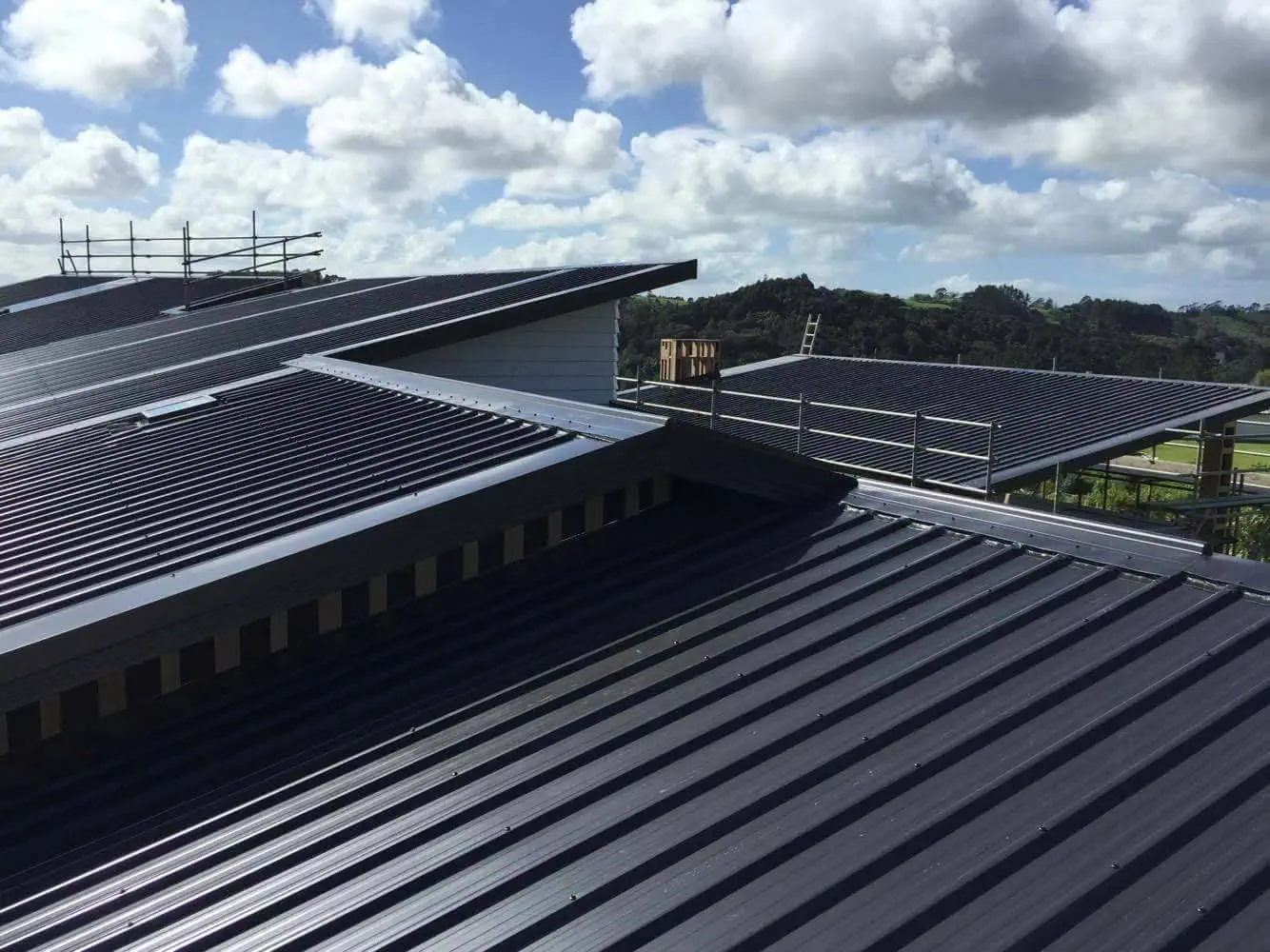 Roof with premium protective coating system deflecting environmental elements